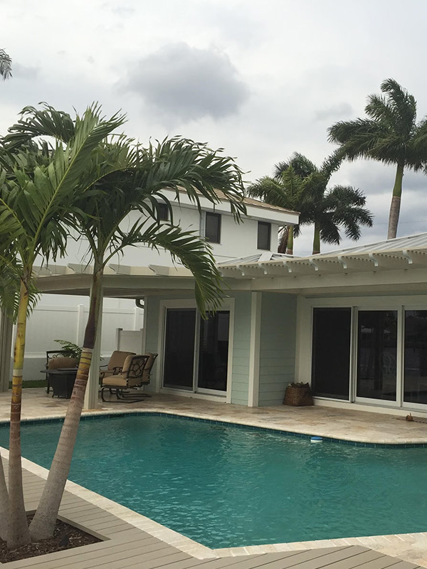 White patio cover in backyard next to pool